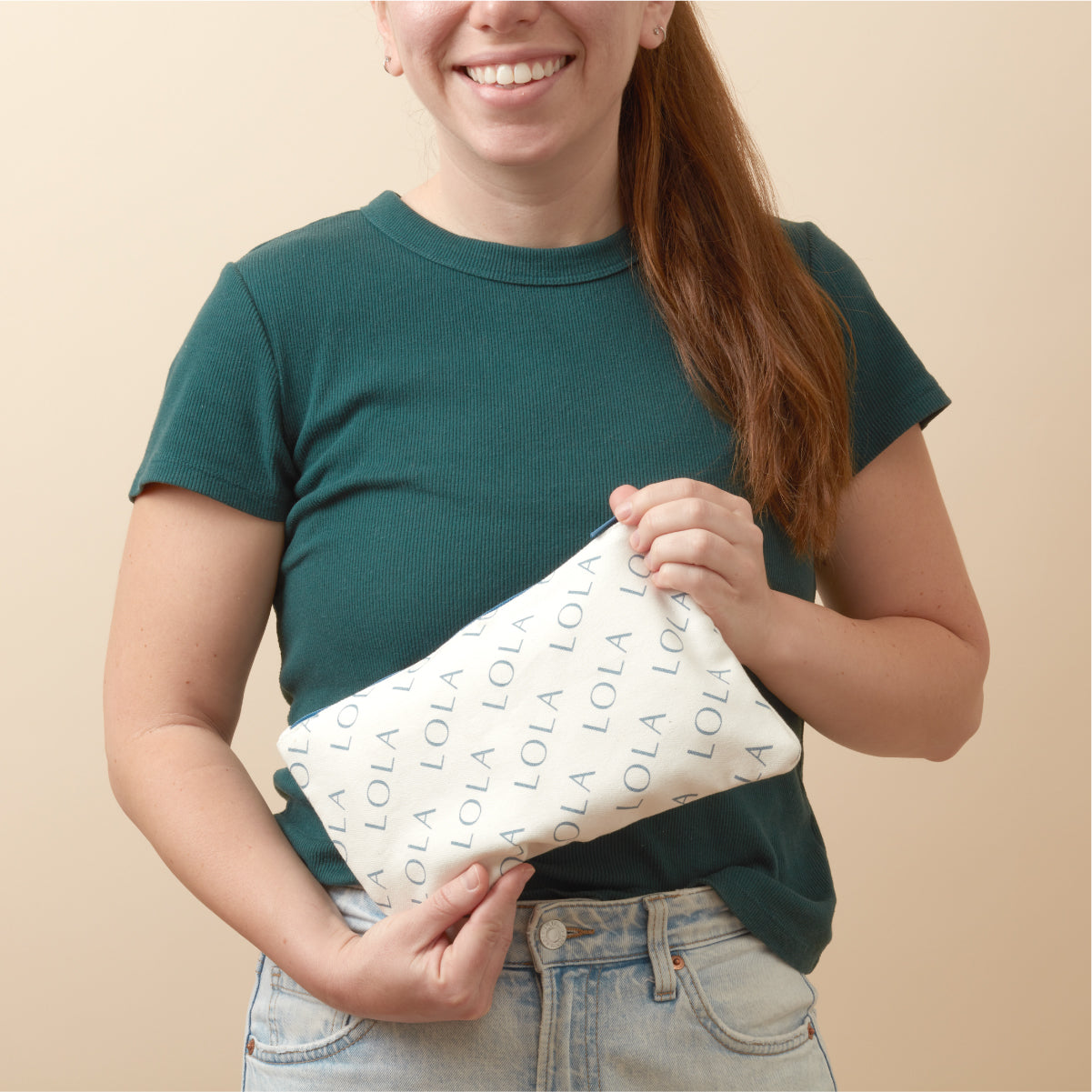 Person holding a white pouch with &